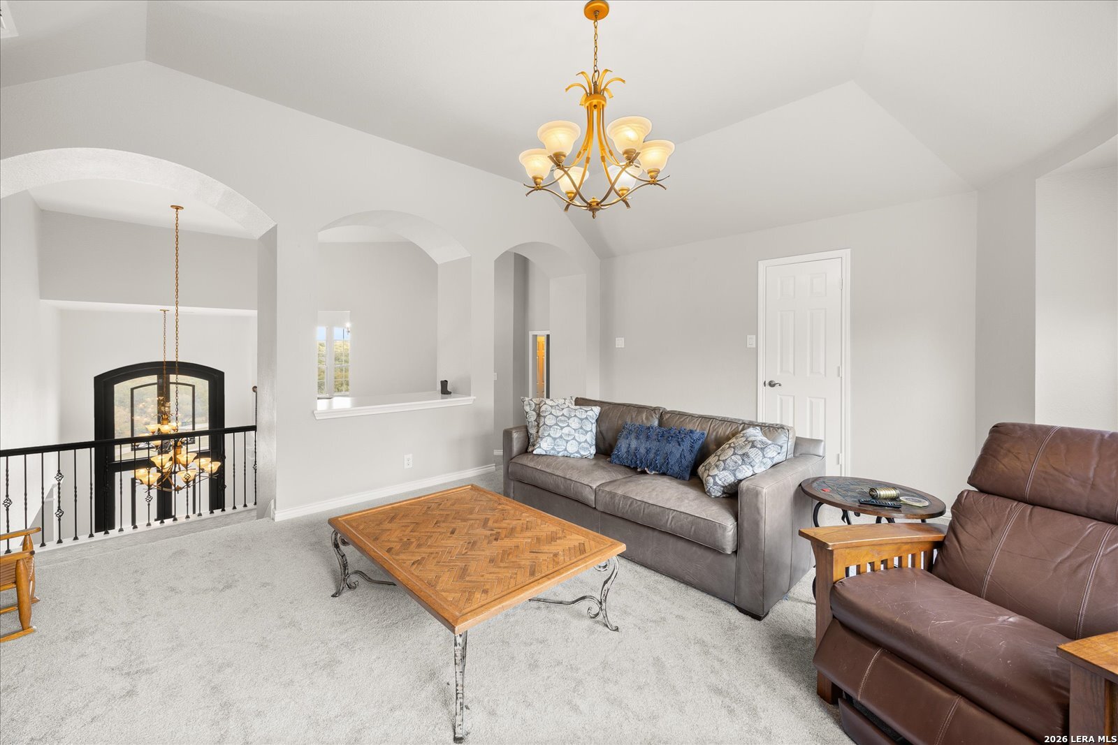 8718 Timberland Trail Fair Oaks Ranch, TX 78015 - Photo 31 of 50 a living room with furniture a dining table and a chandelier