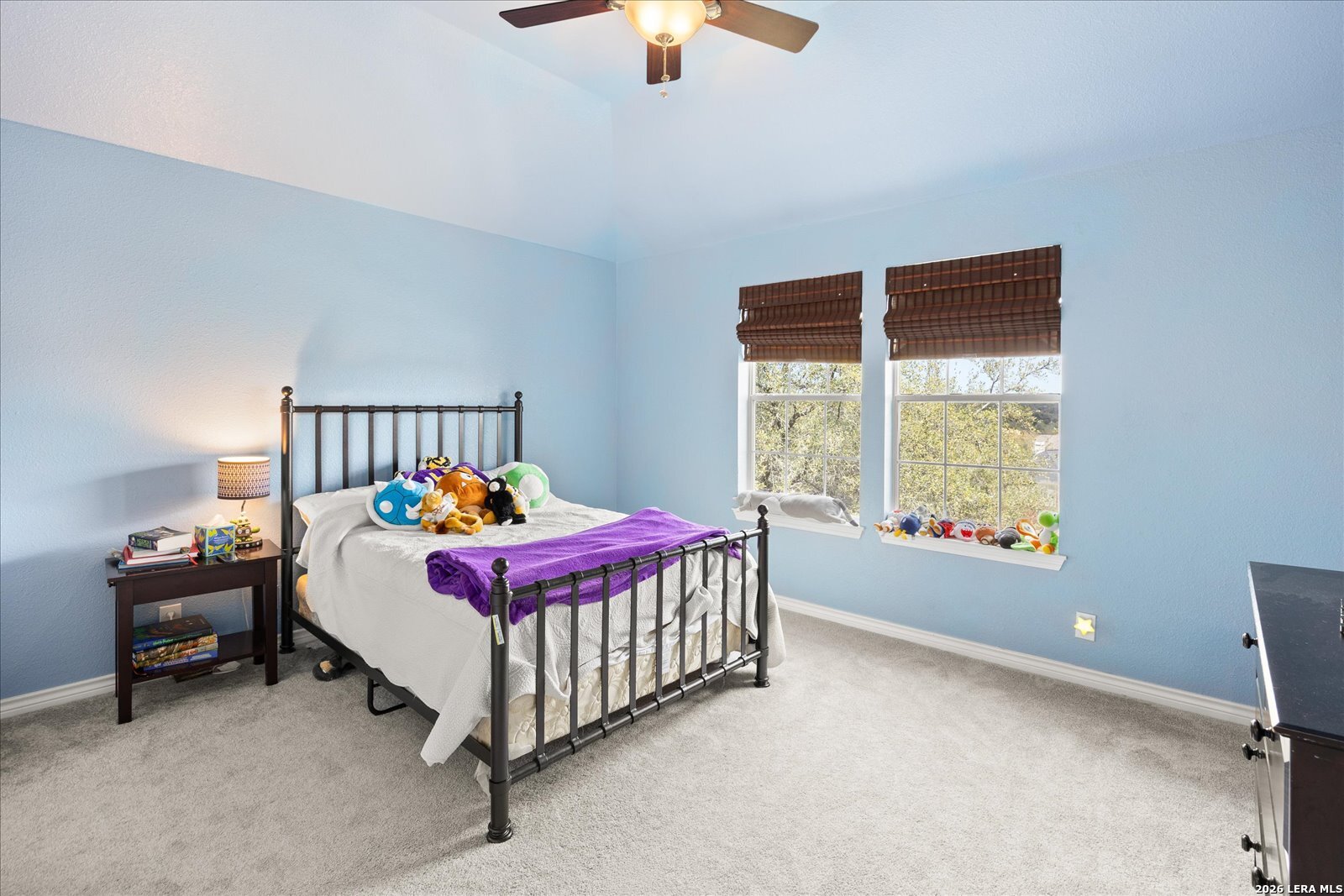 8718 Timberland Trail Fair Oaks Ranch, TX 78015 - Photo 36 of 50 a bed sitting in a bedroom next to a window