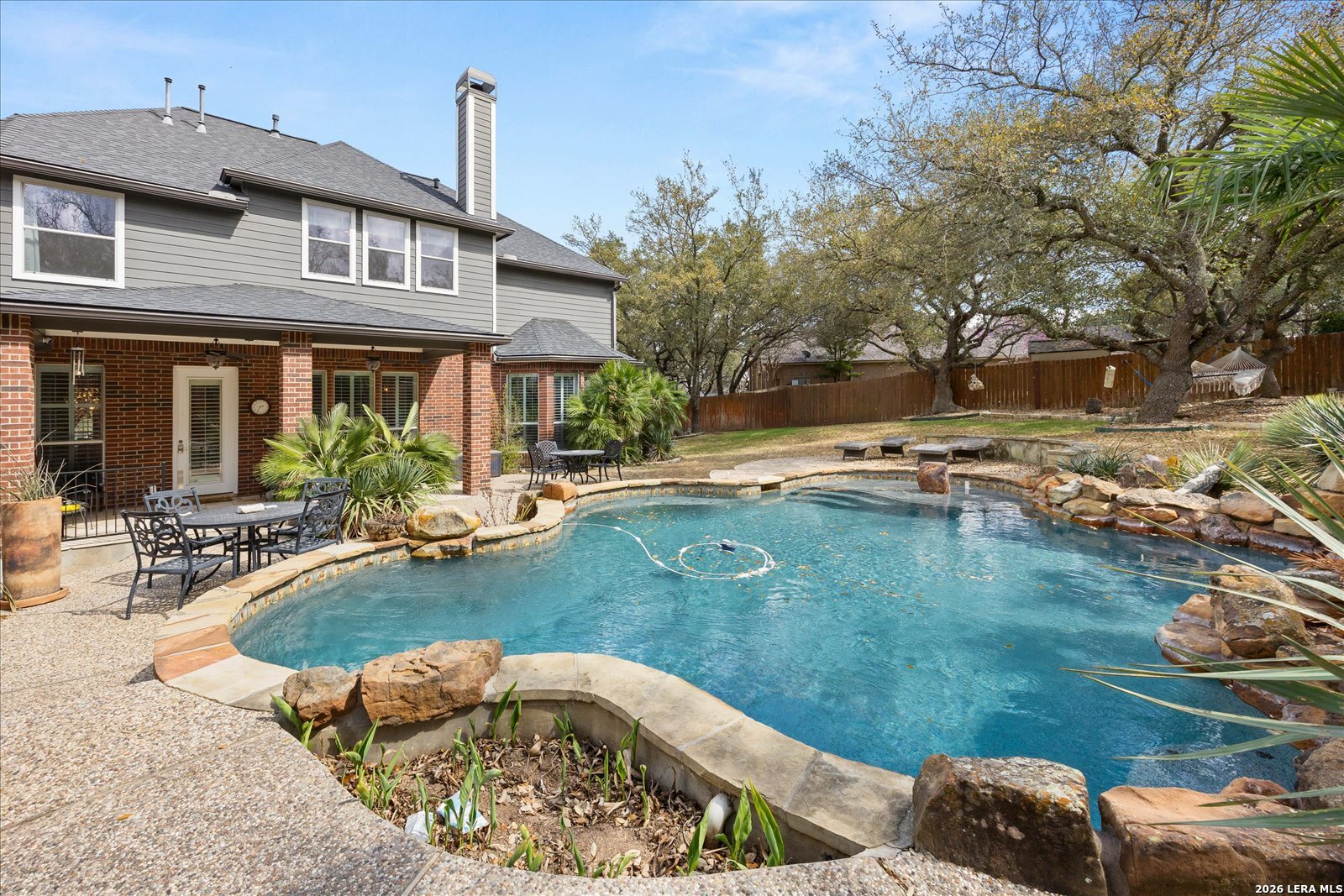 8718 Timberland Trail Fair Oaks Ranch, TX 78015 - Photo 43 of 50 a view of a house with pool and chairs