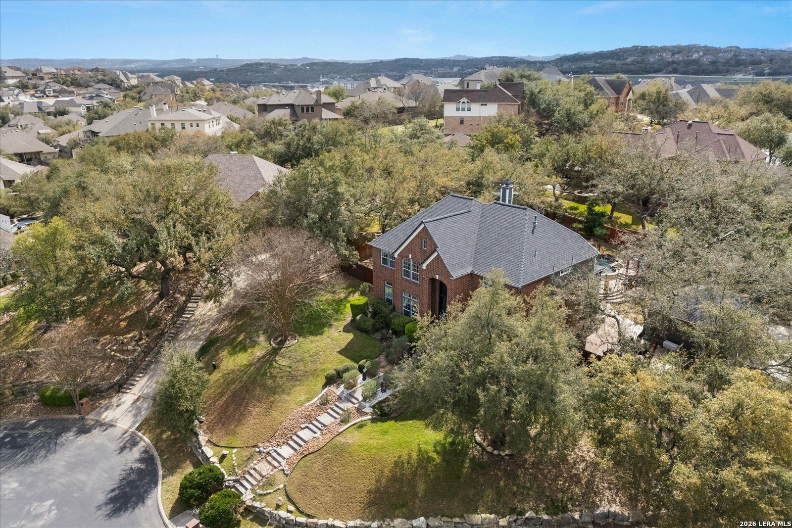 8718 Timberland Trail Fair Oaks Ranch, TX 78015 - Photo 48 of 50 an aerial view of a house with a yard and lake view