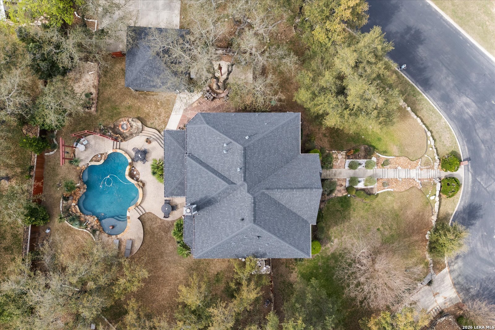 8718 Timberland Trail Fair Oaks Ranch, TX 78015 - Photo 50 of 50 an aerial view of a house with a yard and trees