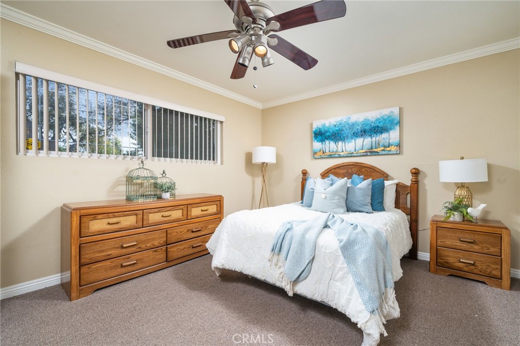 760 West Aster Street Upland, CA 91786 - Photo 11 of 40 a bedroom with a bed and a chandelier