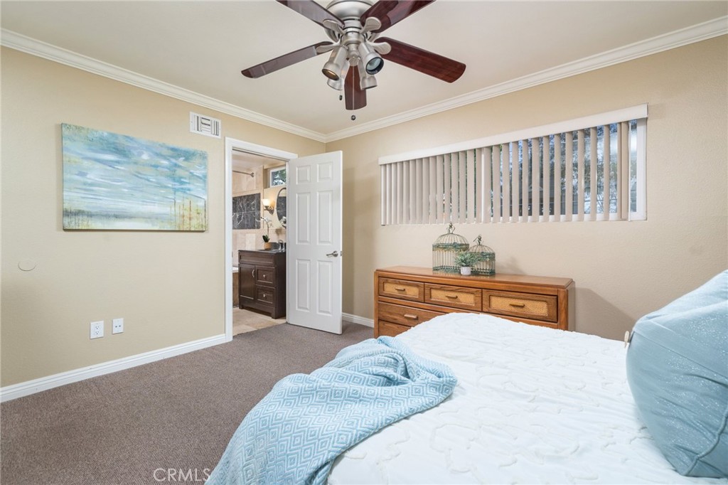 760 West Aster Street Upland, CA 91786 - Photo 12 of 40 a bedroom with a bed and a chandelier