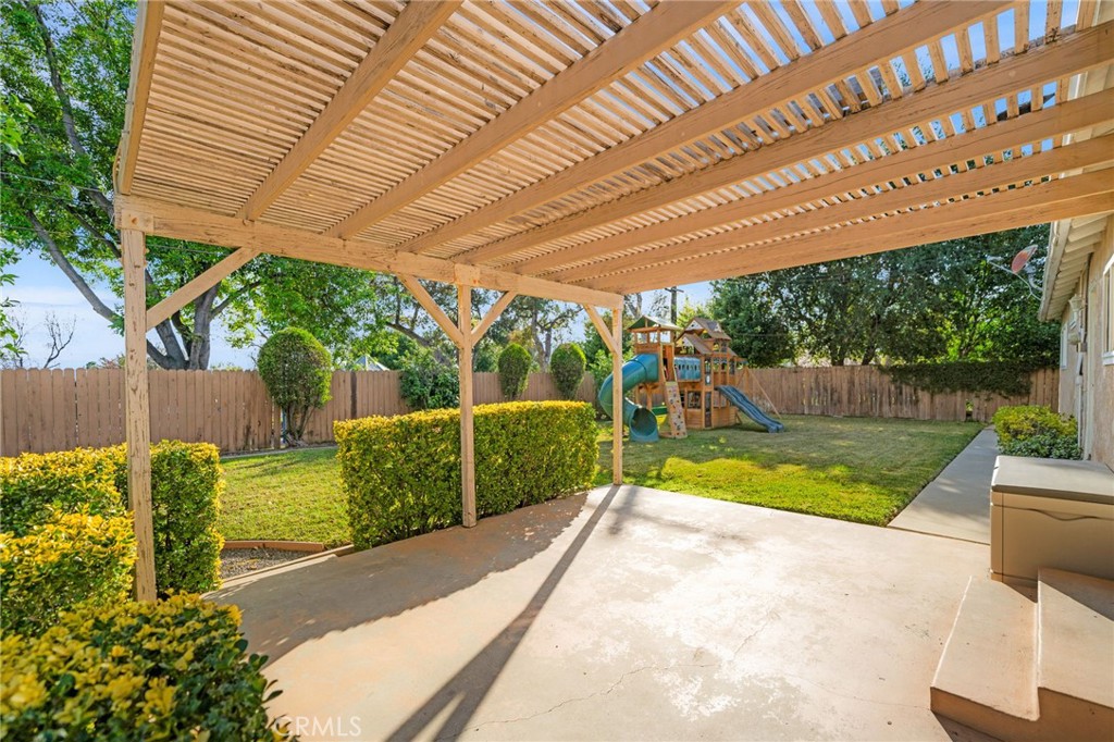 760 West Aster Street Upland, CA 91786 - Photo 25 of 40 a view of a backyard with couches plants and large tree