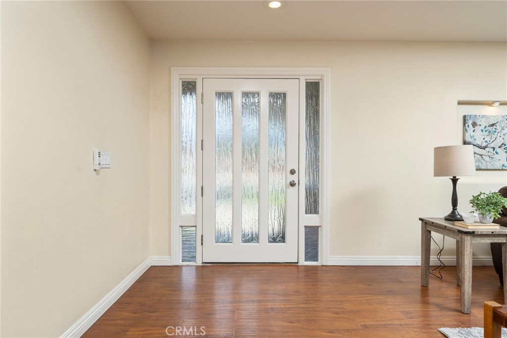 760 West Aster Street Upland, CA 91786 - Photo 3 of 40 a view of an empty room with wooden floor and a window
