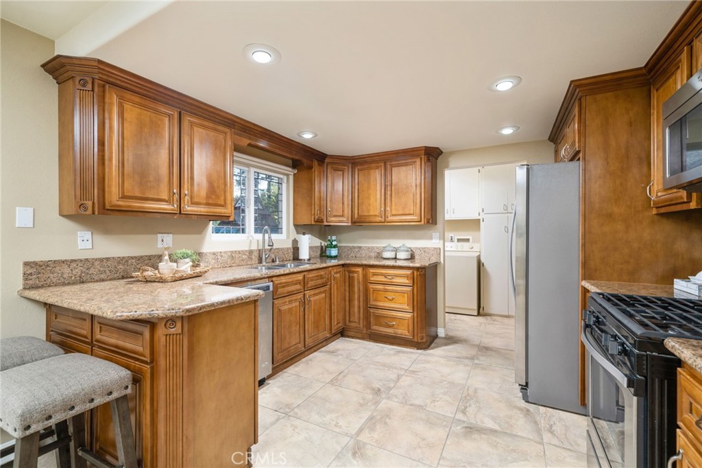 760 West Aster Street Upland, CA 91786 - Photo 7 of 40 a kitchen with stainless steel appliances granite countertop a stove a sink a refrigerator and a microwave