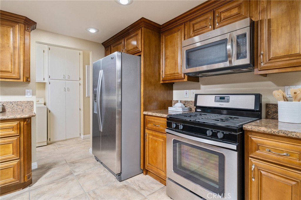 760 West Aster Street Upland, CA 91786 - Photo 8 of 40 a kitchen with stainless steel appliances granite countertop a stove microwave and refrigerator