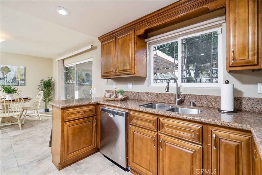 760 West Aster Street Upland, CA 91786 - Photo 9 of 40 a kitchen with kitchen island granite countertop a sink and a counter top space