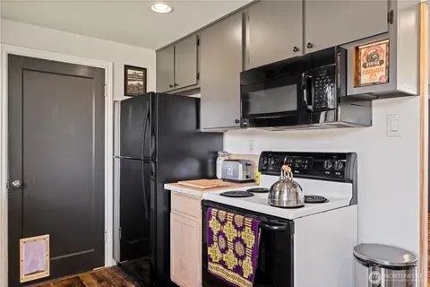a kitchen with stainless steel appliances a stove microwave and refrigerator