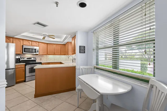 a kitchen with cabinets stainless steel appliances and a sink