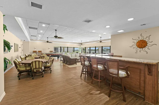 a view of a swimming pool with lawn chairs and a yard