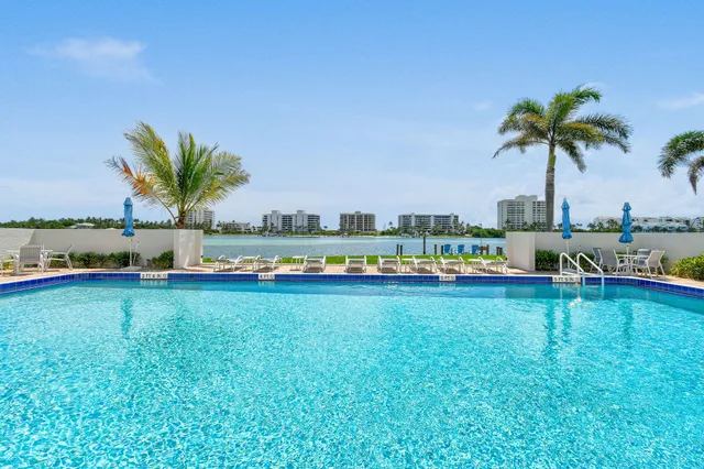 a view of swimming pool with outdoor seating and yard in back