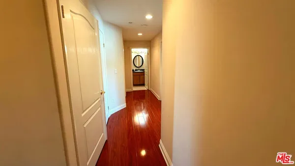 a view of a hallway with wooden floor