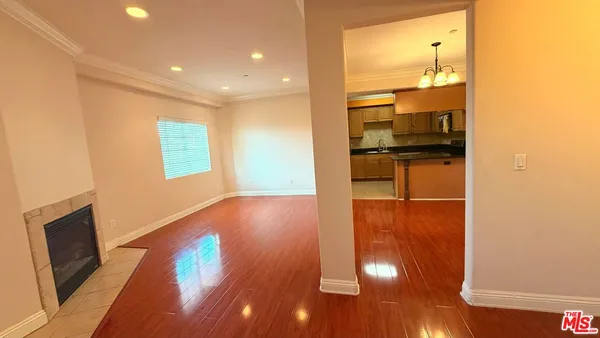 a room with wooden floor and windows