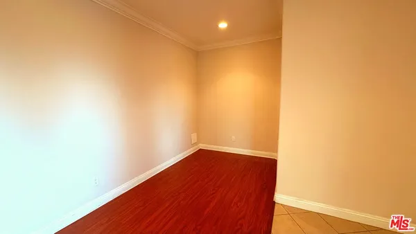 a view of a small space with wooden floor