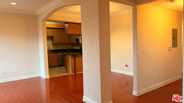 a view of hallway with wooden floor