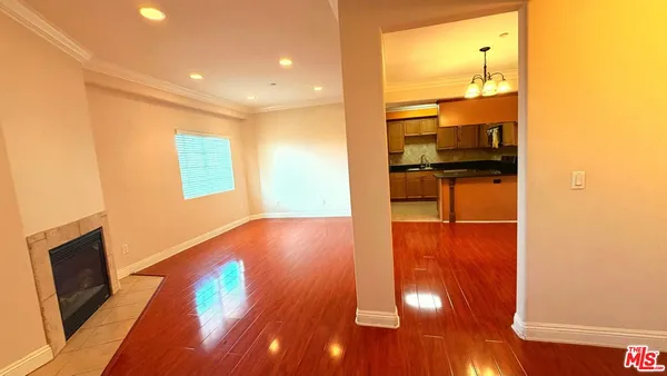 a view of a living room with wooden floor