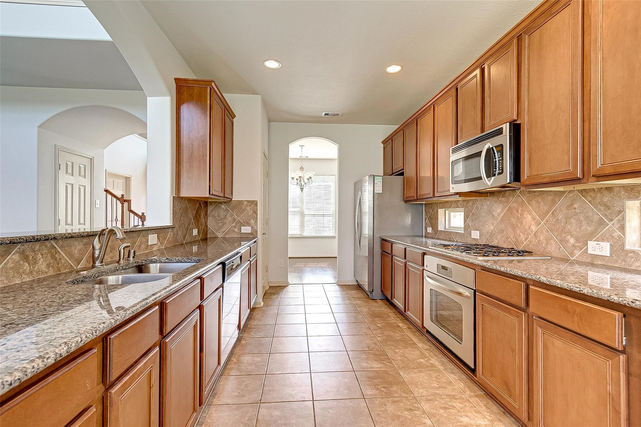 79 West Lasting Spring Circle Spring, TX 77389 - Photo 21 of 48 a large kitchen with stainless steel appliances granite countertop a sink and cabinets