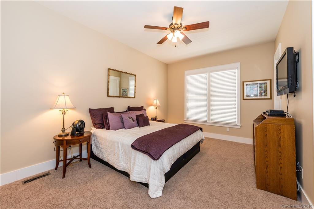225 Coneflower Place, Unit 1405 Fort Mill, SC 29708 - Photo 12 of 22 a spacious bedroom with a bed and a flat screen tv