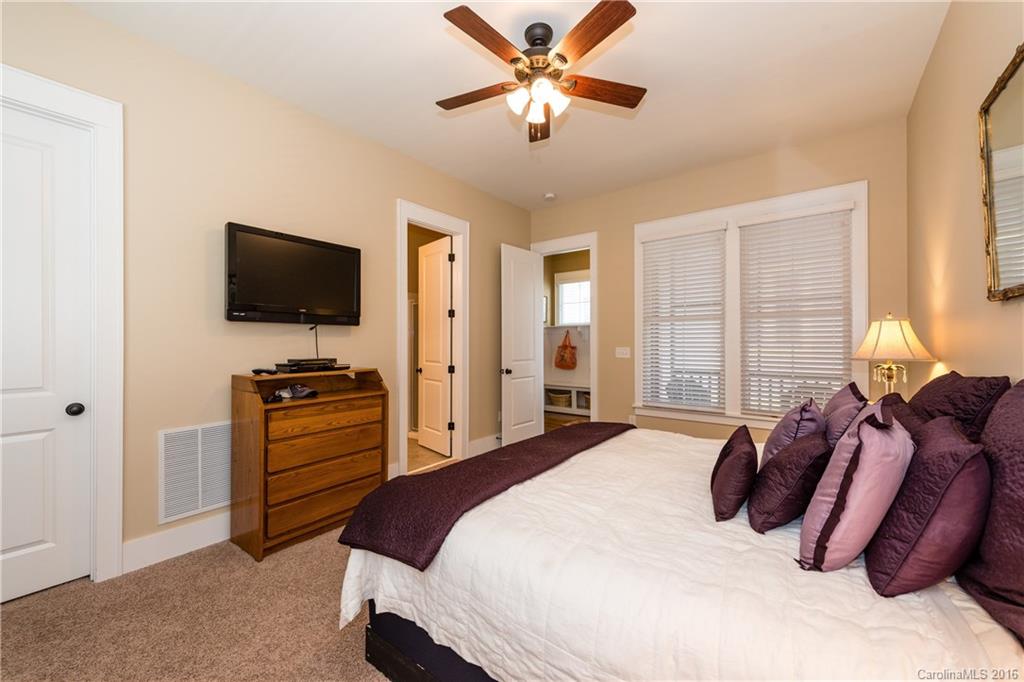225 Coneflower Place, Unit 1405 Fort Mill, SC 29708 - Photo 13 of 22 a bedroom with a bed and a flat screen tv