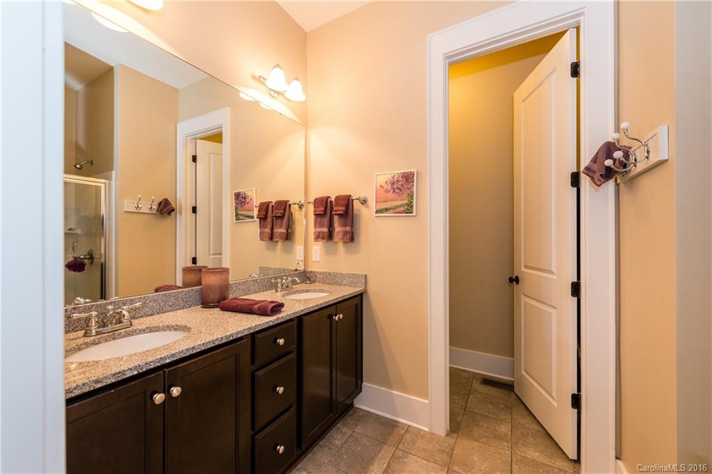 225 Coneflower Place, Unit 1405 Fort Mill, SC 29708 - Photo 14 of 22 a bathroom with a granite countertop sink and a mirror