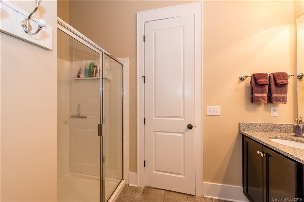 225 Coneflower Place, Unit 1405 Fort Mill, SC 29708 - Photo 15 of 22 a bathroom with a granite countertop sink and a mirror