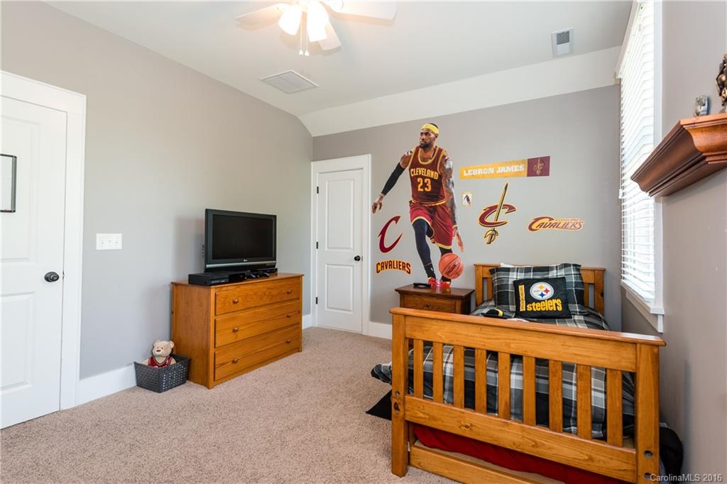 225 Coneflower Place, Unit 1405 Fort Mill, SC 29708 - Photo 19 of 22 a bedroom with furniture and a flat tv screen