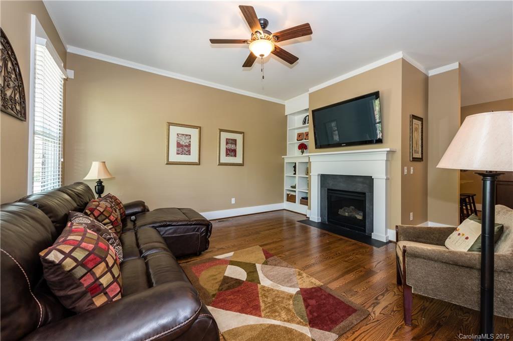 225 Coneflower Place, Unit 1405 Fort Mill, SC 29708 - Photo 6 of 22 a living room with furniture a flat screen tv and a fireplace