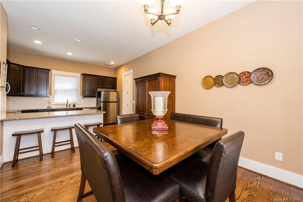 225 Coneflower Place, Unit 1405 Fort Mill, SC 29708 - Photo 9 of 22 a kitchen with a dining table chairs and refrigerator