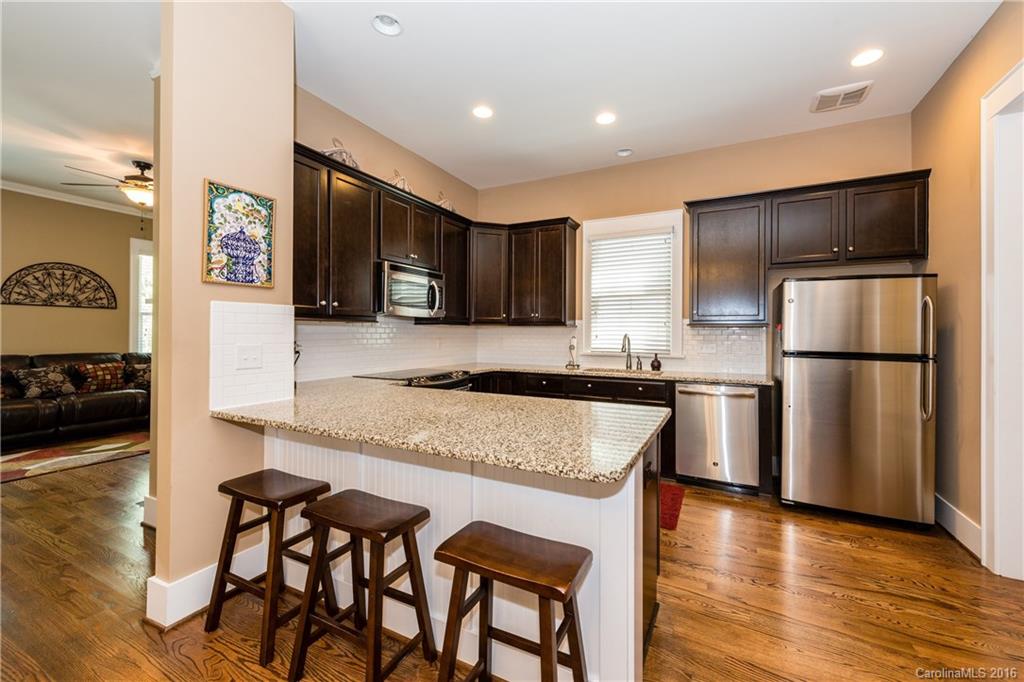 225 Coneflower Place, Unit 1405 Fort Mill, SC 29708 - Photo 10 of 22 a kitchen with granite countertop a refrigerator and a stove top oven