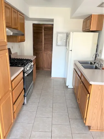 a kitchen with stainless steel appliances granite countertop a stove and a sink