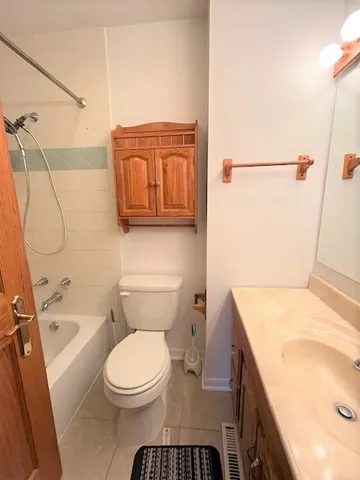 a bathroom with a toilet a sink and bathtub