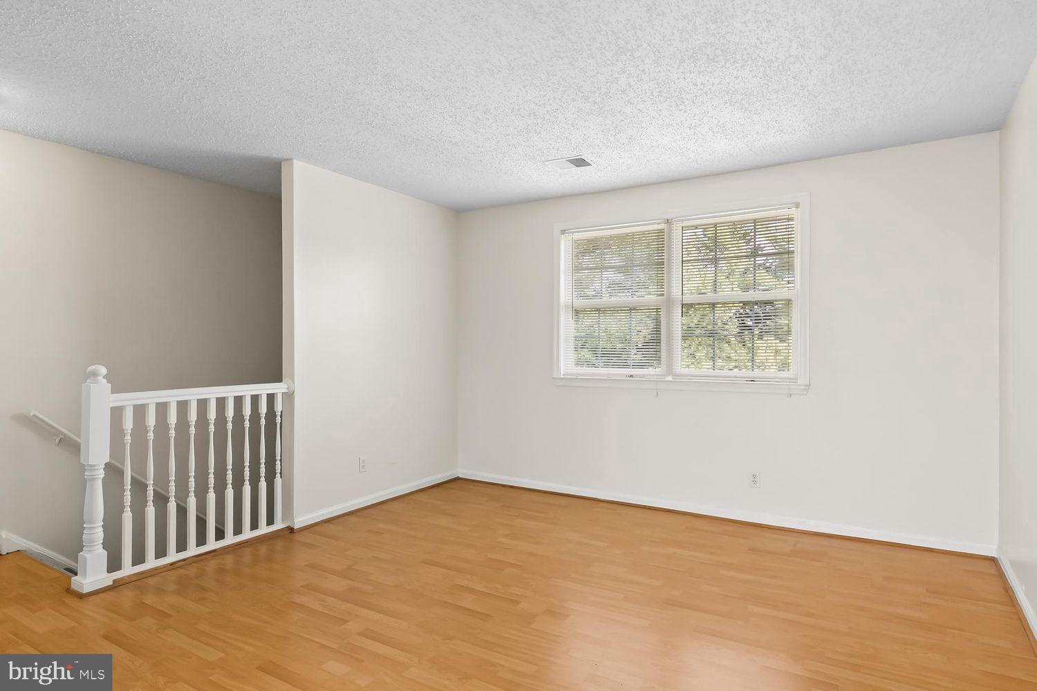 125 Eaves Mill Road Medford, NJ 08055 - Photo 4 of 10 a view of an empty room with wooden floor and a window