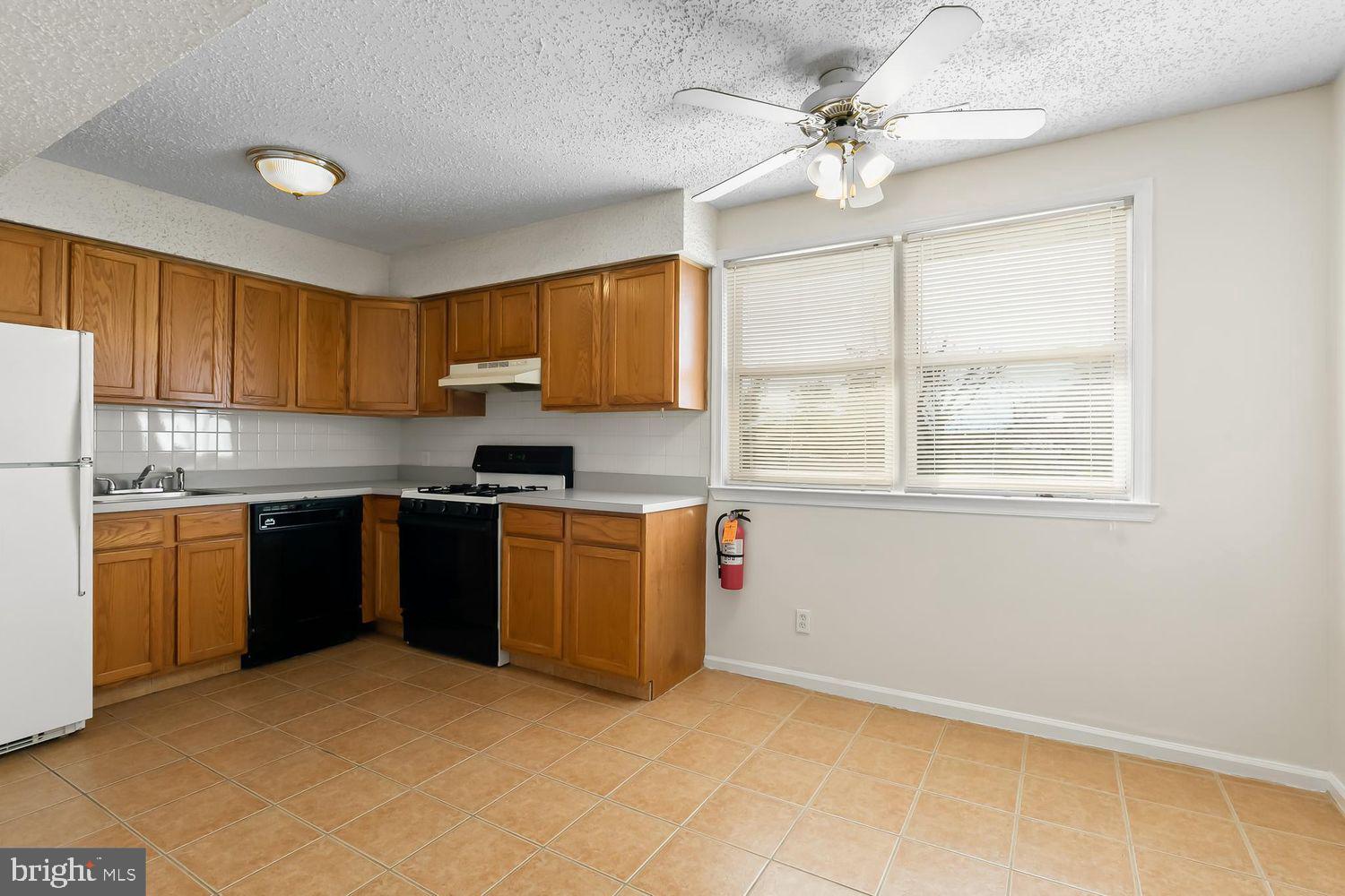 125 Eaves Mill Road Medford, NJ 08055 - Photo 5 of 10 a kitchen with granite countertop a stove sink and cabinets