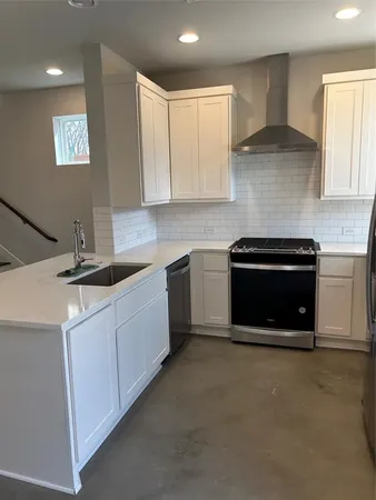 a kitchen with cabinets a sink and a stove