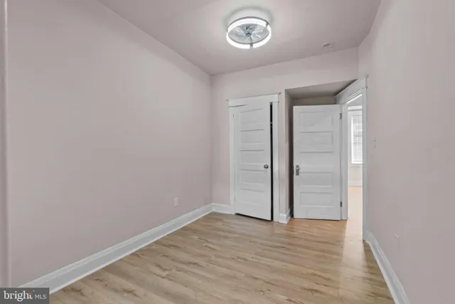 an empty room with wooden floor