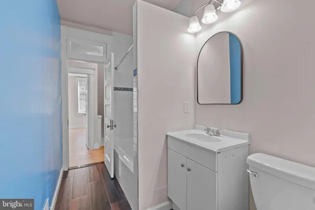a bathroom with a toilet sink and mirror