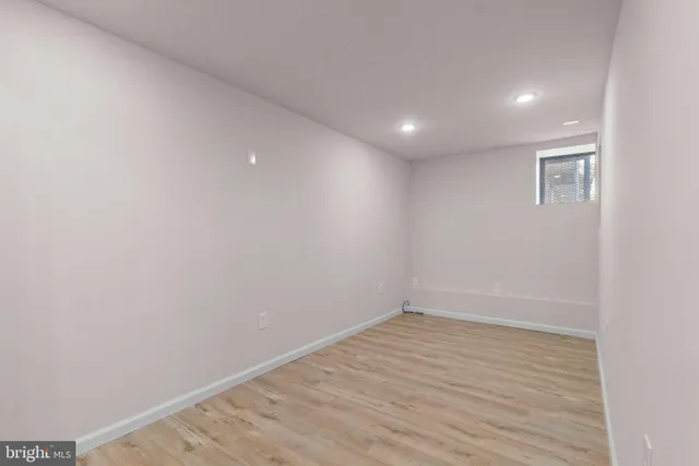 a view of room with wooden floor and fan