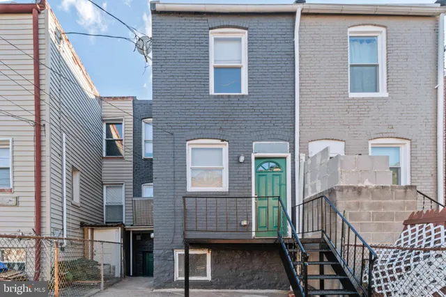 a view of a brick house with many windows