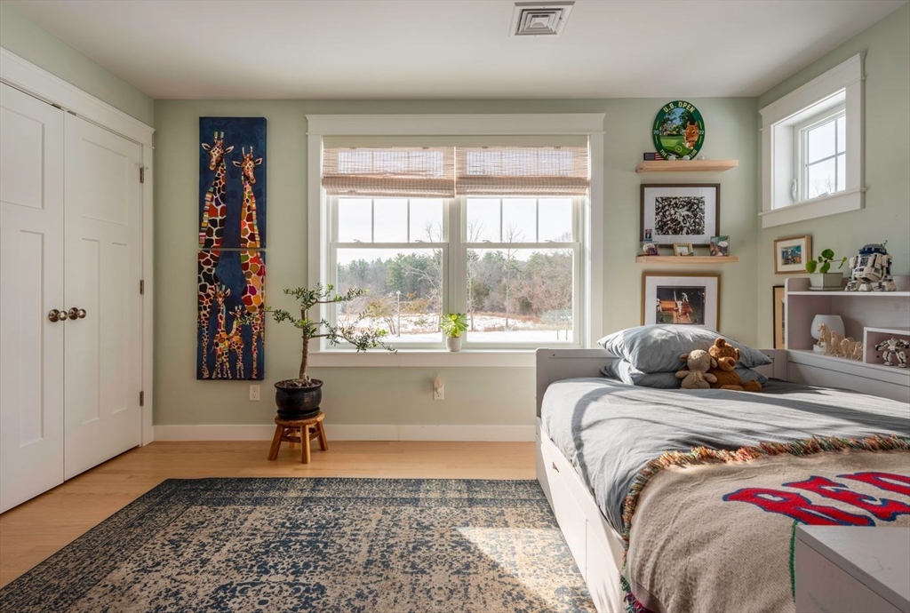 5 John West Road Exeter, NH 03833 - Photo 20 of 33 a bedroom with a bed and a window