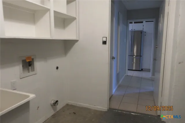 a view of storage and utility room with closet