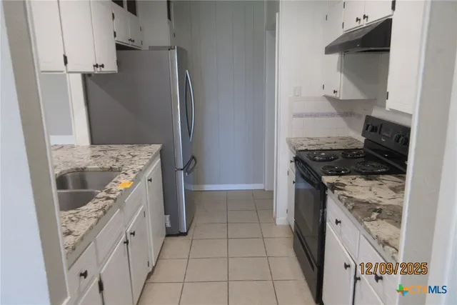 a kitchen with a stove and a refrigerator