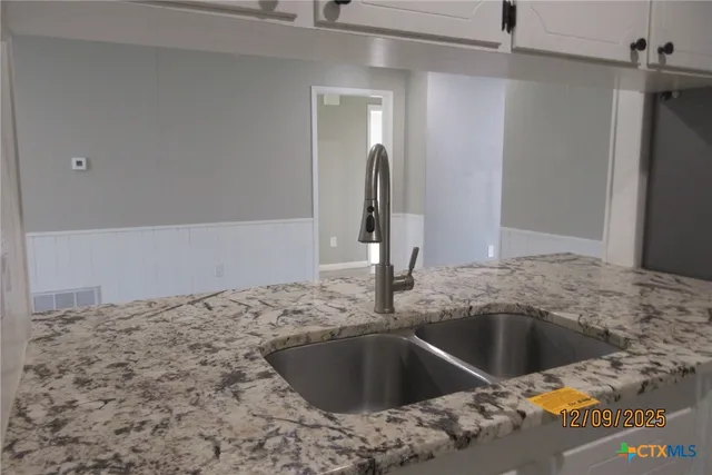 a kitchen with a sink and a refrigerator