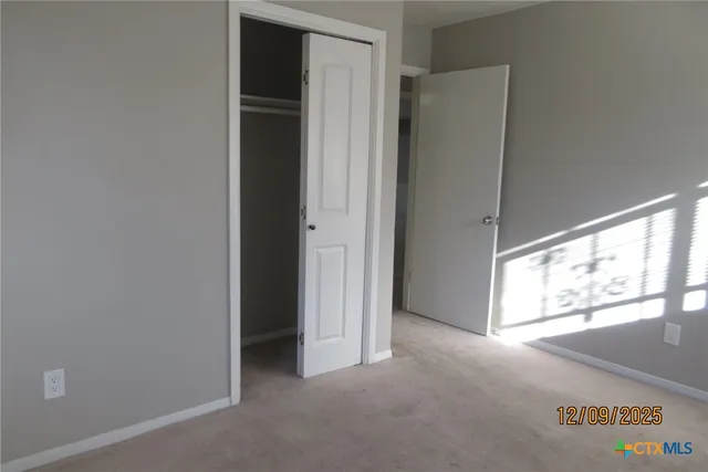 a view of an empty room and a window