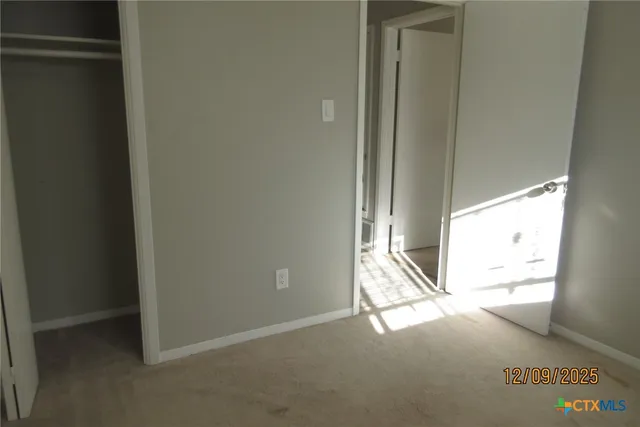 a view of an empty room and a window