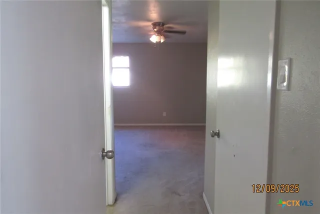 a view of an empty room with a fan