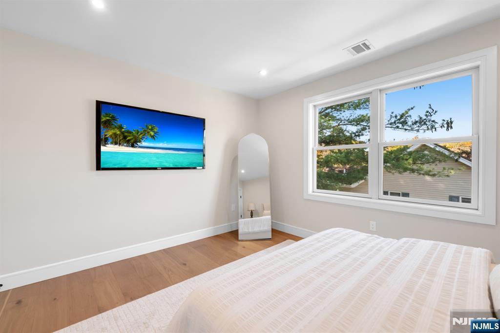 92 West Main Street Ramsey, NJ 07446 - Photo 29 of 47 a bedroom with a bed and a large window