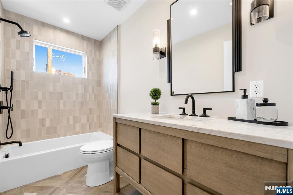 92 West Main Street Ramsey, NJ 07446 - Photo 31 of 47 a bathroom with a granite countertop sink toilet and shower