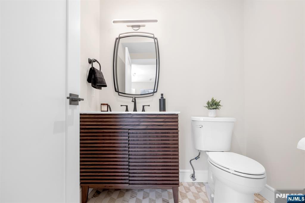 92 West Main Street Ramsey, NJ 07446 - Photo 38 of 47 a bathroom with a toilet sink and mirror