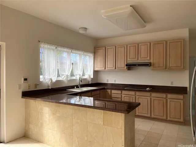 a kitchen with stainless steel appliances granite countertop a sink and a white cabinets